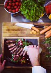 Image showing top view of Chef finishing steak meat plate