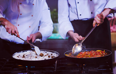 Image showing team cooks and chefs preparing meals