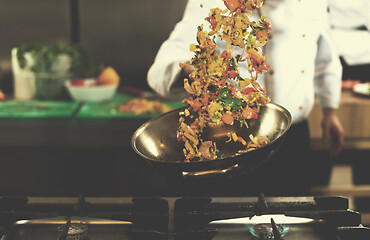 Image showing chef flipping vegetables in wok