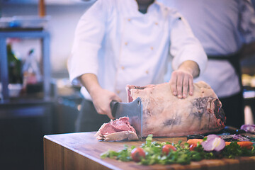 Image showing chef cutting big piece of beef