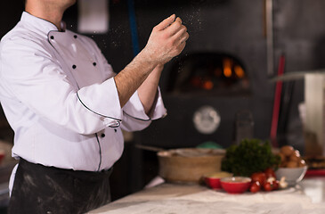 Image showing chef throwing up pizza dough