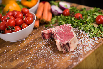 Image showing Juicy slice of raw steak on wooden table