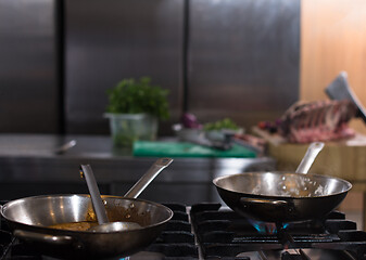 Image showing chef preparing food, frying in wok pan