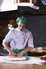 Image showing chef preparing dough for pizza