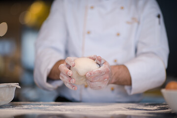 Image showing chef hands preparing dough for pizza