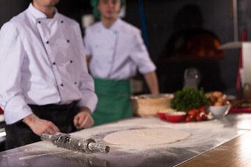 Image showing chef preparing dough for pizza