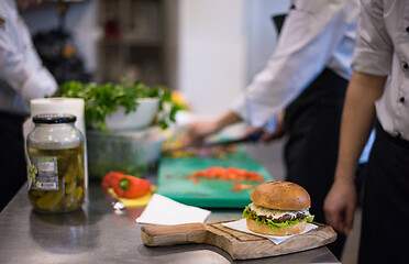 Image showing chef finishing burger