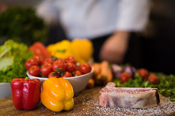 Image showing Juicy slice of raw steak on wooden table