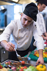 Image showing Chef finishing steak meat plate