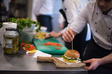 Image showing chef finishing burger