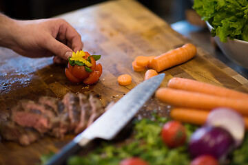 Image showing closeup of Chef hands preparing beef steak