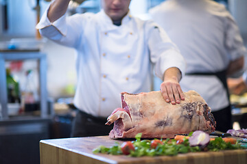 Image showing chef cutting big piece of beef