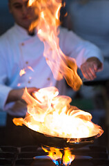 Image showing Chef doing flambe on food