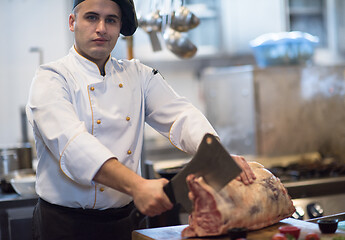 Image showing chef cutting big piece of beef