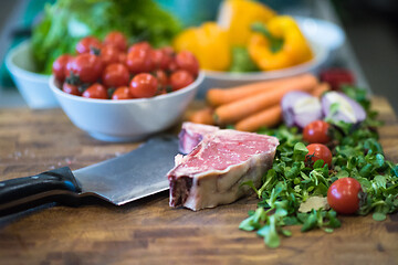 Image showing Juicy slice of raw steak on wooden table