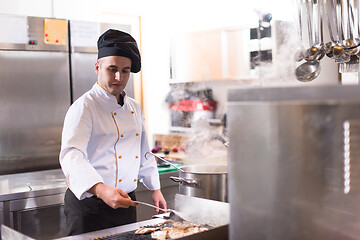 Image showing chef preparing food, frying on grill