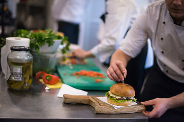 Image showing chef finishing burger