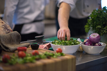 Image showing chef hand serving vegetable salad