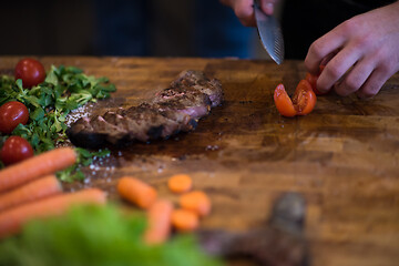 Image showing closeup of Chef hands preparing beef steak