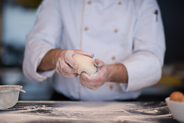 Image showing chef hands preparing dough for pizza