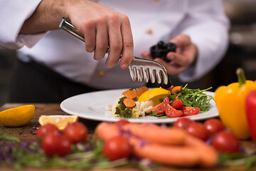 Image showing chef serving vegetable salad