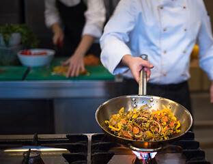 Image showing chef flipping vegetables in wok