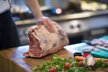 Image showing chef cutting big piece of beef