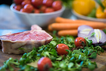 Image showing Juicy slice of raw steak on wooden table