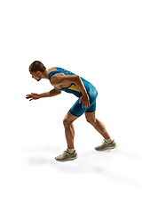 Image showing Young caucasian man running or jogging isolated on white studio background.