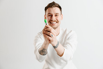 Image showing Happy man looking at pregnancy test at studio