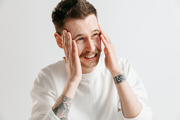 Image showing Man having headache. Isolated over gray background.