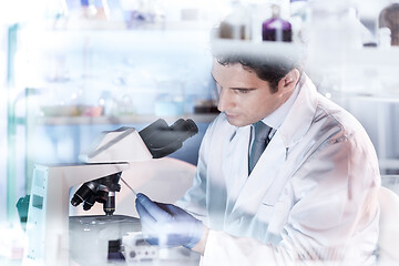 Image showing Life science researcher microscoping in genetic scientific laboratory.