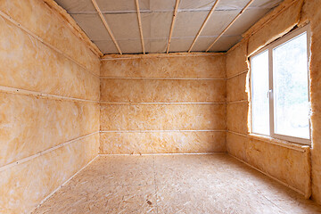 Image showing Roll insulation on the inner walls of a small room