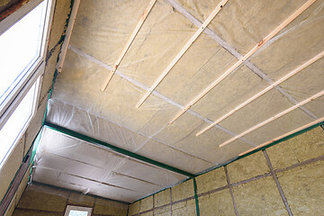 Image showing Insulation of the roof from the inside with mineral wool in a wooden country house