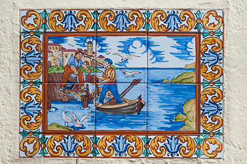 Image showing BARCELONA, SPAIN - JUNE 2, 2013: Picture of a mosaic depicting the fisher in Spain. An image of specially painted tiles and pieces of glaze on the wall of a house in Barcelona