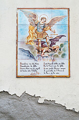 Image showing BARCELONA, SPAIN - JUNE 2, 2013: Picture of a mosaic depicting the angel and devil. An image of specially painted tiles and pieces of glaze on the wall of a house in Barcelona