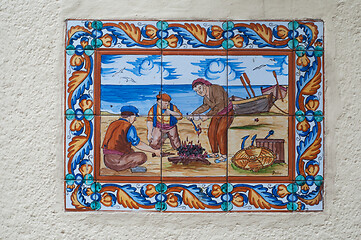 Image showing BARCELONA, SPAIN - JUNE 2, 2013: Picture of a mosaic depicting the fisher in Spain. An image of specially painted tiles and pieces of glaze on the wall of a house in Barcelona