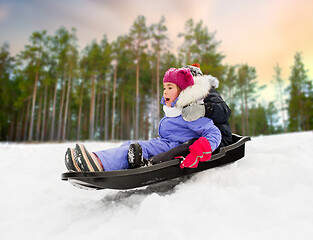 Image showing little kids sliding on sled down hill in winter