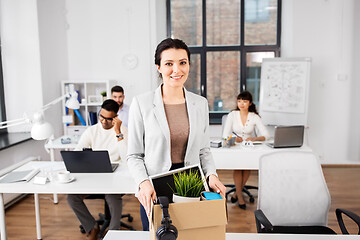 Image showing happy businesswoman with personal stuff at office