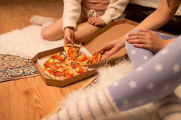 Image showing happy female friends eating pizza at home