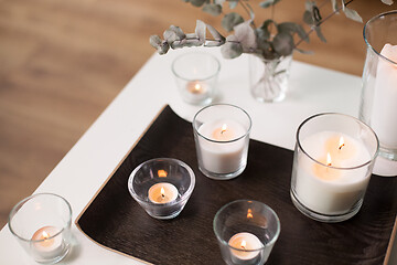 Image showing candles and branches of eucalyptus on table