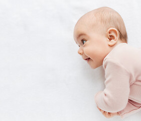 Image showing sweet baby girl lying on white blanket