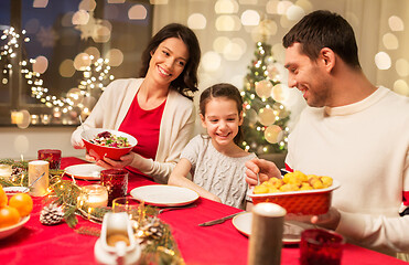 Image showing happy family having christmas dinner at home