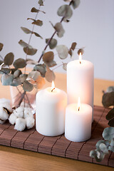 Image showing candles and branches of eucalyptus on table