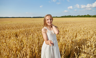 Image showing happy girl taking selfie on cereal field