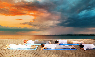 Image showing group of people making yoga exercises outdoors