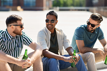 Image showing happy male friends drinking beer on street