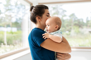 Image showing mother holding baby daughter at home