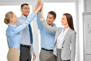 Image showing happy business team making high five at office