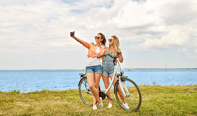 Image showing teenage girls with bicycle taking selfie in summer